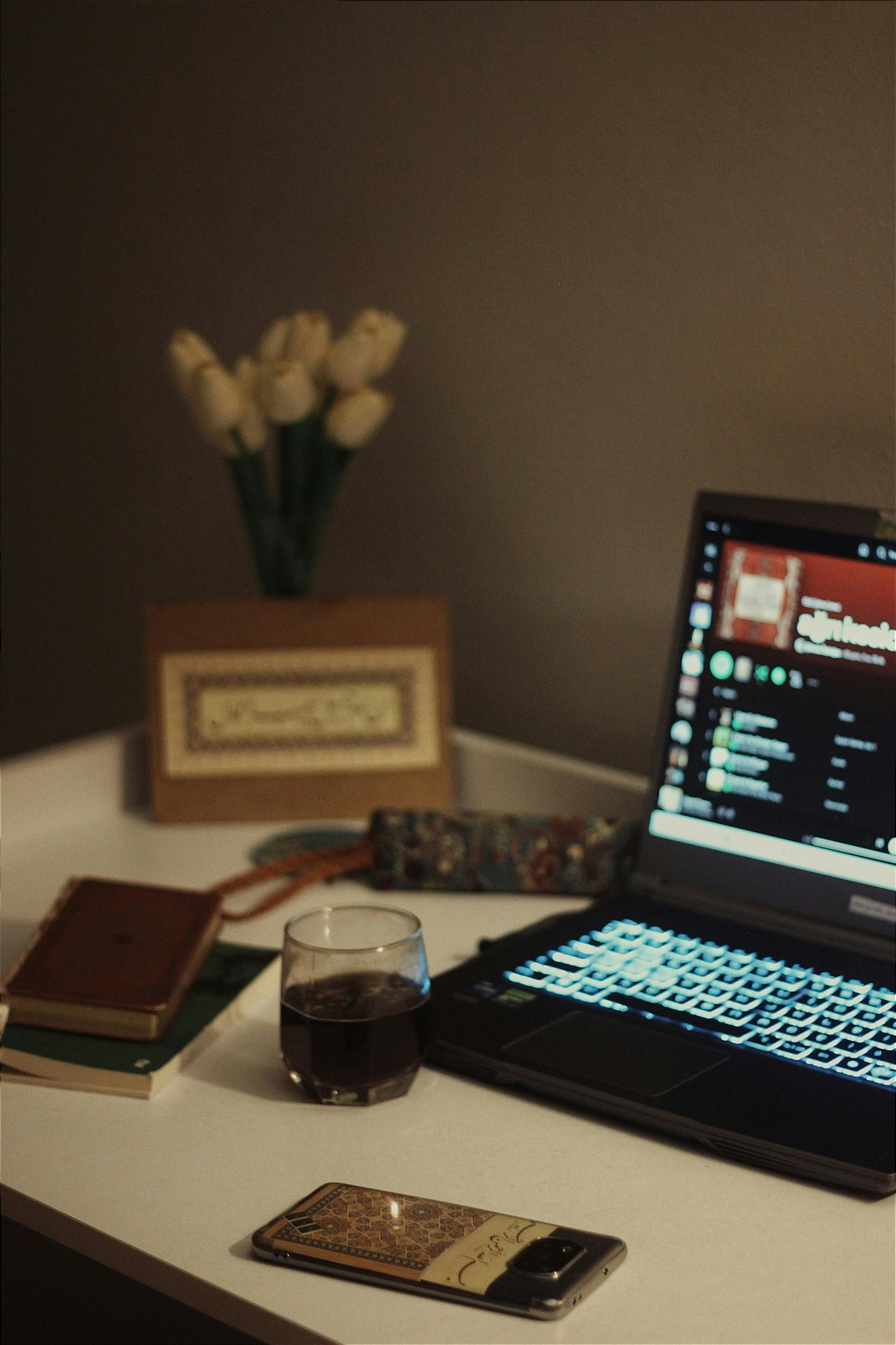 A cozy study setup with a laptop, coffee, and books on a table, perfect for productivity.